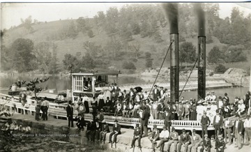 View of people gathered on and around the Isaac M. Mason steamboat.