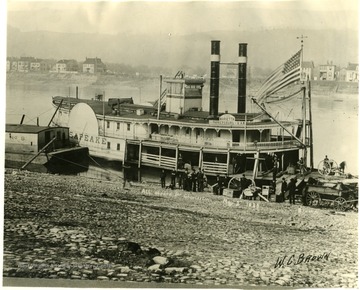 Several items of the West Virginia State Archives sit onshore waiting to be loaded on the "Chesapeake". After having a "floating state capitol", the issue was settled in 1885, when Charleston was named the permanent site.