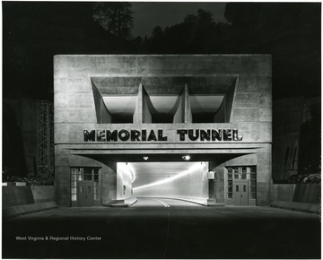 Dramatic night view of the northern portal to Memorial Tunnel, dedicated to all the West Virginians who have served or are now serving in the armed forces of our country, is the most challenging construction of the entire Turnpike, the cost of which was nearly $5,000,000.
