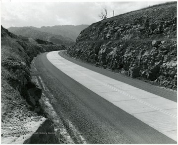 Sandstone, which is a most difficult material to drill and blast, is one of the predominant materials that had to be excavated for the roadway construction, as shown in this section of the highway north of Long Branch, Fayette County.