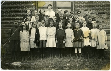 "Martha Dixon, Louise Corey, Edna Roberts, Tweed Thompson, unknown, Agnes Burns, Alara La Fon, Janie Lilly, Mary Davis, unknown, Josephine Mahood.  Second Row: Sylvan Fisher, unknown, Chilton Farmer, unkown, Quincy Gunnoe, Davis, Eugene Robertson, Derb Vipperman.  Last Row: Dorothy Phipps, G. Ford, unknown, Miss Amelia Wise (teacher), Willis Mauck, unknown, Noel Griffith, Johnny Cooper and unknown."