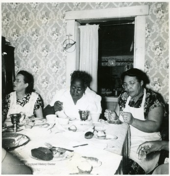 Three African-American women participate in a Make Your Own Mix demonstration.