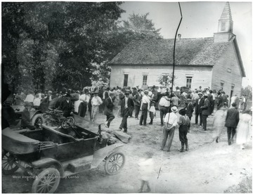 Early model cars can be seen in the foreground.
