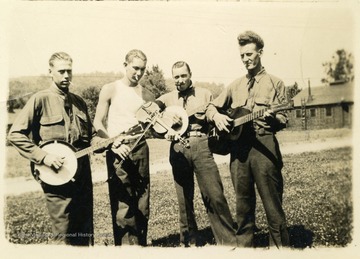 Four men with musical instruments, including banjo, guitar, and violin at Camp Crawford. Camp Crawford was a base for Company 1512 in the Charleston District, Fifth Corps Area.