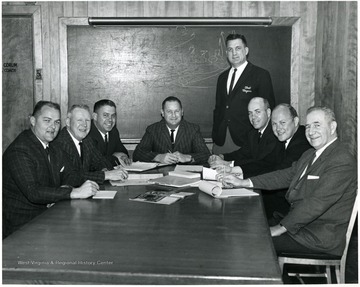 'Standing, Head Coach Gene Corum; sitting, left to right, Bob Patton, Ed Shockey, Chick Donaldson, Dick Ware, Ralph Chancey, Galen Hall, Russ Crane.'