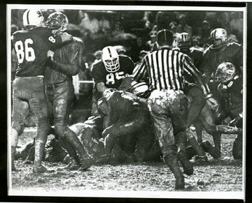 Football players are in a muddy pile up during the 1969 Peach Bowl in Atlanta, Georgia where West Virginia beat the University of South Carolina. 