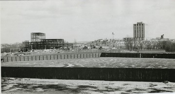 View of old Hawley Field, Creative Arts Center being constructed and Engineering building on hill.