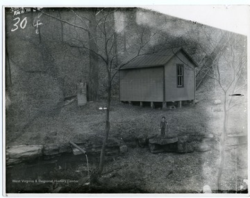 'A view of Hick House which was built in 1892 in the ravine just below Woodburn Hall on Falling Run. The Hick House was used for storage of bodies [corpses] for study by medical students.'