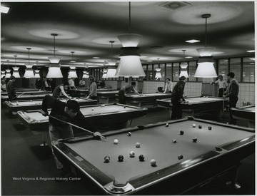 Students playing pool at the recreation room.