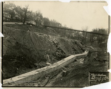 Preparing ground for excavation of Mountaineer Field, West Virginia University, looking northeast up Falling Run Hollow.