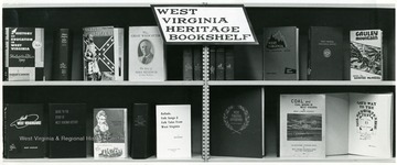 West Virginia themed books on two shelves.