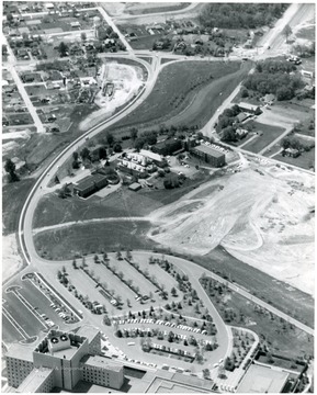 'New W.V.U. Medical Center parking area at W. Va. University and new faculty and student housing on bare spots. Monongalia County Hospital in center.' 