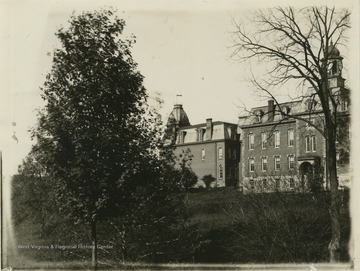'Martin Hall and Woodburn Hall. The brick for the Martin Hall was burnt where the heating plant now stands. The building was built in 1870, at the same time the center part of the Old Experiment Station was built.'