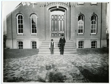 'Yoko and the late George Simmins who was janitor here in 1897.  Taken in front of Woodburn Hall.  Simmins is an engineer in Charleston at the present time.  He taught the colored school in Morgantown for a number of terms.'