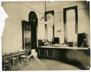 Office in Woodburn Hall featuring telephone, typewriter, electric or gas lighting, safe, and roll-top desk, along with other standard furnishings.  