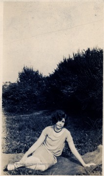 Woman sitting in the grass.