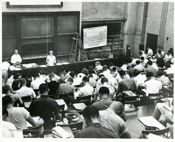 'In Chemistry Building Auditorium before 1965 remodeling.  Probably a freshman class.'