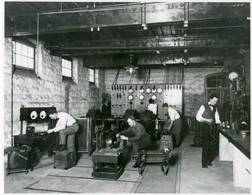 WVU College of Engineering students working in electrical engineering laboratory under the office in Mechanical Hall.  'Rheostat nicknamed 'baby carriage.'