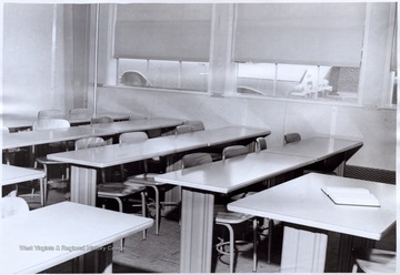 'Two classrooms are furnished with tables instead of arm-tablet chairs for students.' Image from page 12 of 'Progress Report on Civil Engineering Submitted to Education Committee, Engineers Council for Professional Development 29 West 39th Street, New York 18, New York by College of Engineering, West Virginia University, Morgantown, West Virginia.' Original photo may be found in this publication located in the WV Collection book collection. 