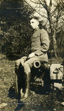 Louis Watson Chappell in uniform (possible Us Army) seated on a cannon. Chappell  became a member the WVU faculty in 1922 and is known for his extensive research and collection of Appalachia Music.