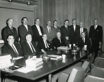 Seated, first on left Hans McCord; Bill Thompson, standing last on right; Chuck Haden, State Representative, standing sixth from left; John Pyles, standing fifth from left; Dr. Paul A. Miller, President of West Virginia University, seated, head of table.