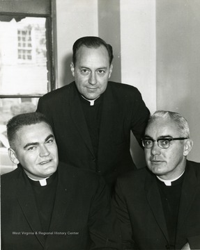 Father Edward Hofler; Father Robert T. Scott; Unidentified.