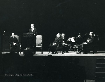 On Stage: Dr. Irvin Stewart, Speaking; Joseph Gluck, Seated at right; American Arts Trio - Portnoy, Drucker, Engberg.