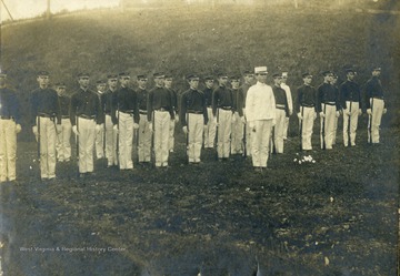 'Drill field at WVU. Ellison in all white uniform'.