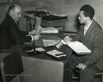 First black WVU graduate (Journalism, 1954) interviewing Thomas Fulton, head of Social Work Department, for D.A.