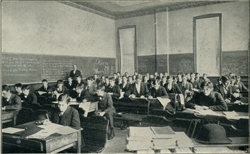 Students taking a test, with the instructor monitoring.