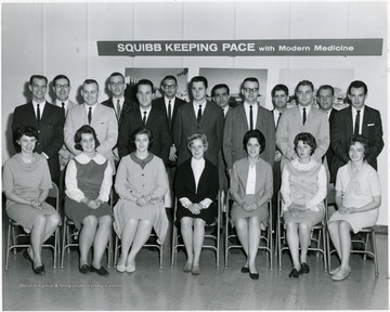 Seated third from right, Martha McPhail. Standing third from right, directly behind Martha, Hugh McPhail.