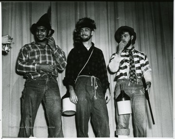 Three male students dress as mountaineers for Mountaineer Week.