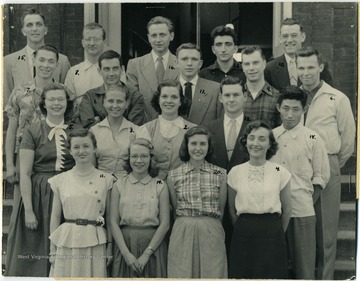 Names signed on the back of photo '1. Donald Hubbard; 2. Verna Hall; 3. Lucille Marland; 4. Catherine Fidley; 5. Lee Hanson; 6. Jack Wilson; 7. Nick Stepoulos; 8. Don Engel; 9. Steve Barezney; 10. Pam Springer; 11. Deanie Fleming; 12. Bennie Kent; 13. Geo G. Gidnodis; 14. Juanita L. Boggess; 15. Stan Book; 16. Hanno Zochinsen (special student from Germany); 17. Gene T. Miller; 18. Kyung Won Lee (Korean Student); 19. Robert K. Liston (not in picture); 20. Jeanne Beidler;' Message attached to group portrait says, 'Dr. Reed, You're a Square Shooter.'