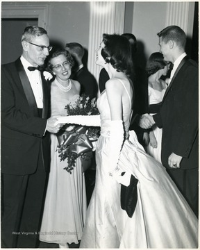 West Virginia University President and Mrs. I. Stewart greeting Sharon Andrews, Monticola editor and Roger Tompkins, Student Body President at a formal event.