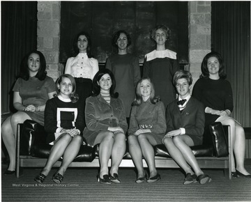 Members of Senior Panhellenic Council gather in front of a fireplace in Mountainlair. Back Row from left to right Carolyn Peluso; Mary Fowler; Nancy Davenport; bottom row unknown