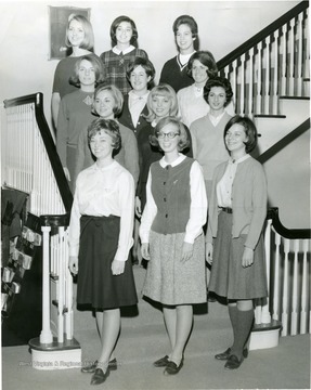 Members of Associated Women Students Activities Council pose on a staircase in Elizabeth Moore Hall.