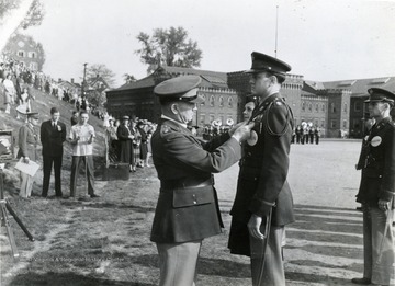 Officer pinning a cadet.