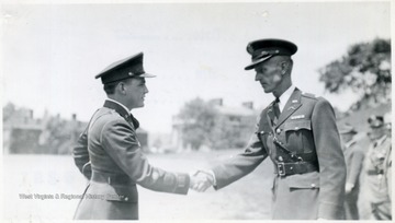 A cadet shakes hands with an officer.