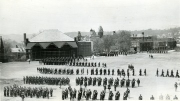 Cadets march in Drill Field, in the background Commencement Hall and the Agricultural Experiment Station.