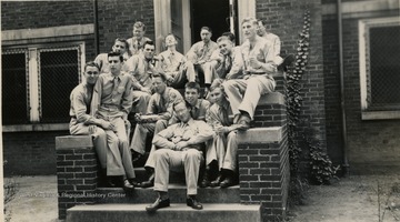A group of cadets of Army Specialized Training Program pose casually on stairways. See original for identification.