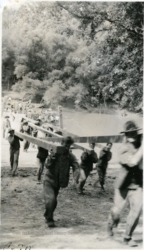 Cadets carrying large pieces of wood.