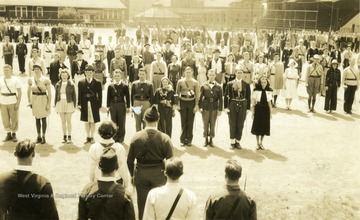 Cadets and sponsors assemble in Drill Field on Old Clothes Day; many dressed for an occasion.