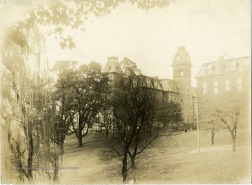 View of Woodburn Hall, a portion of Martin Hall and the adjacent grounds and trees.