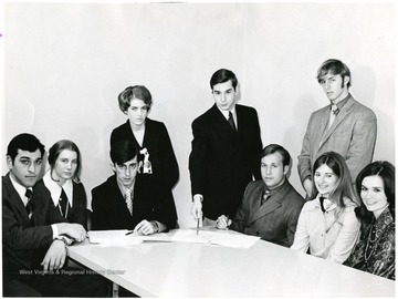 Seated from Left to Right: Ed Howard, Sally Steptoe, Glen Communtzis, Alan Woodford, Laura Dudley, Linda Gray. Standing from Left to Right: Phyllis Huff, John "Doc" Richmond, Donn Brown.