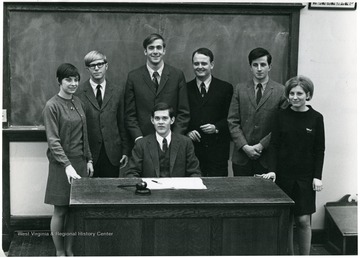 'Seated, John Nutter. Left to right: Sandy Buckley, Greg Evers, John Hoblitzell, George Blizzard, Al Martine, Linda Stenger.'