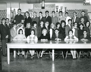 Members of Hillel Foundation gather behind a table for a group portrait.