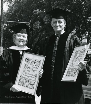 Mrs. T. L Harris, left, and H.A. Stansbury are inducted to WVU's Order of Vandalia.