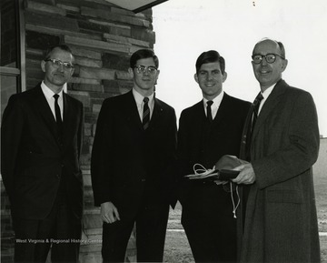'Scene from the Mar. 23-27, 1967 international meeting of the Association of Women Students held here during the 100th Anniversary observance shows, from left to right: David Hess, director of student educational services and assistant provost of WVU; Jim Mullendore, president of the WVU student body; David C. Hardesty, former president of the WVU student body; and Edward Eddy, president of Chatham College in Pittsburgh.'