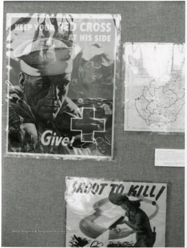 Exhibit in second floor gallery of Mountainlair. Poster says, 'Keep your red cross at his side, give.'