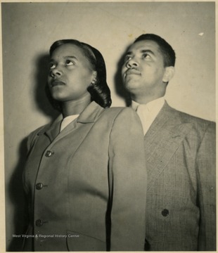 A male and female student pose for a portrait.